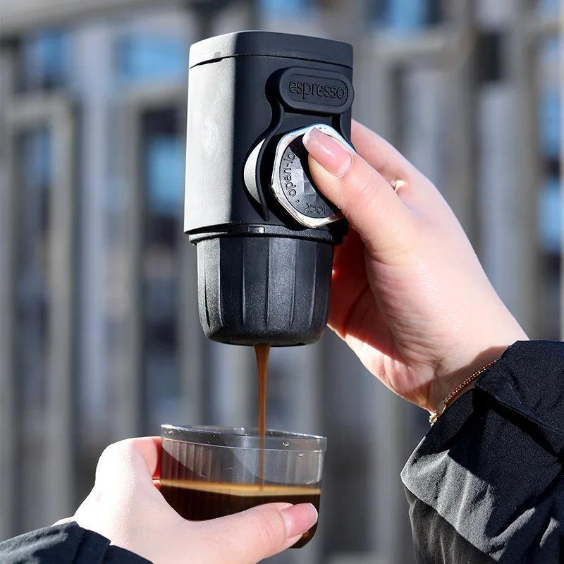 Hand pressing the Bubblitz portable coffee maker to extract espresso
